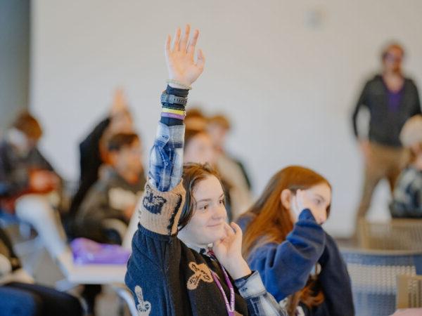 a group of people raising their hands